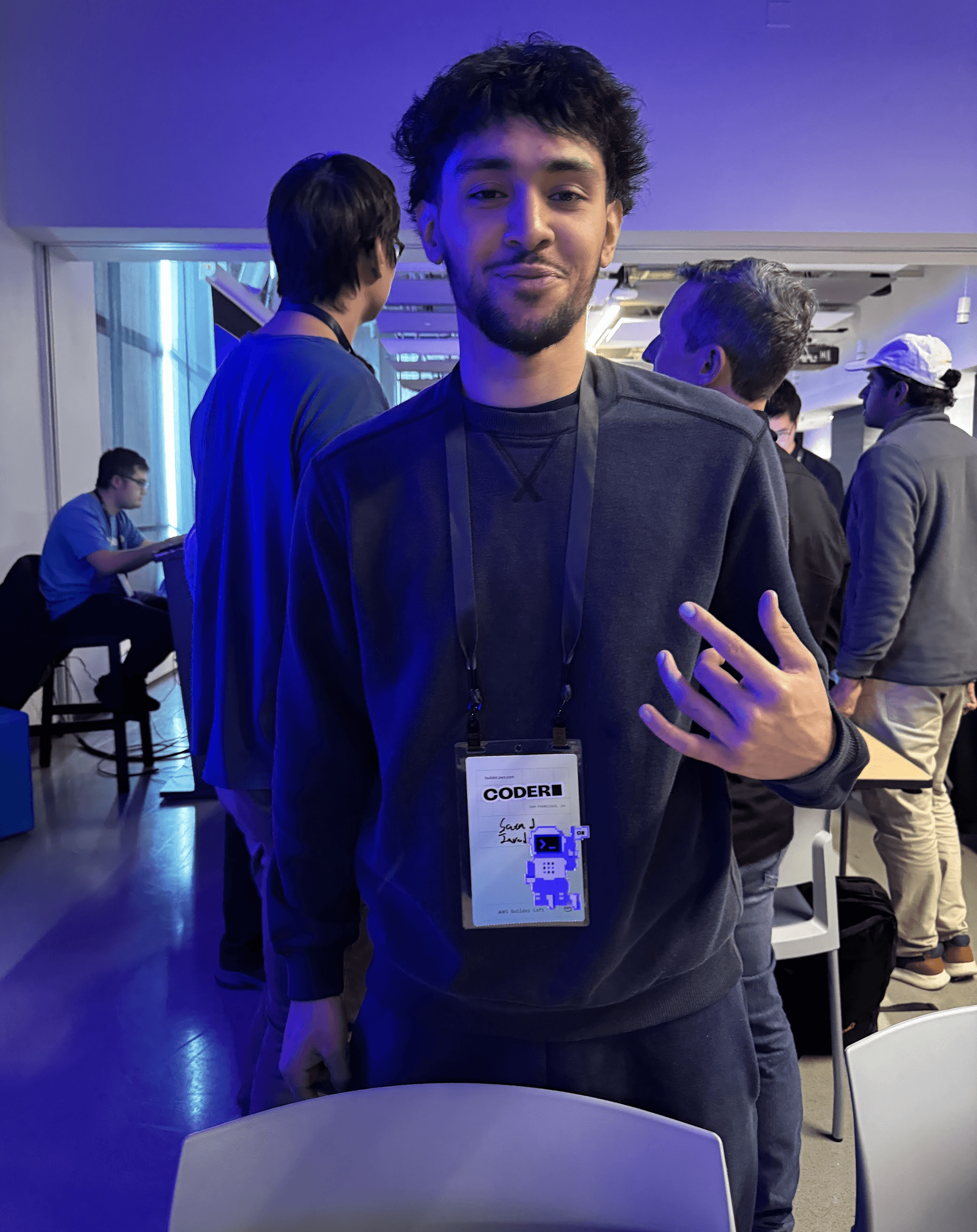 person wearing a lanyard in a room where conference talks take place