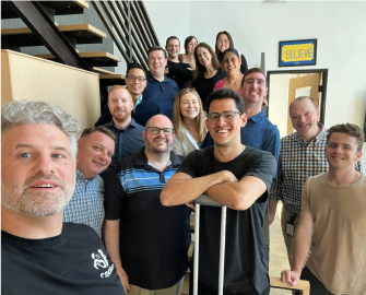 group of Coder employees posing on a staircase