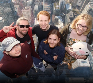 group of Coder employees posing on an observation deck above skyscrapers